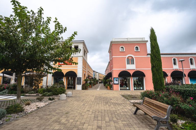 Fai shopping immerso nella storia di Palmanova. L'esterno del Palmanova Outlet Village parla di eleganza e tradizione nel cuore di Friuli Venezia Giulia.